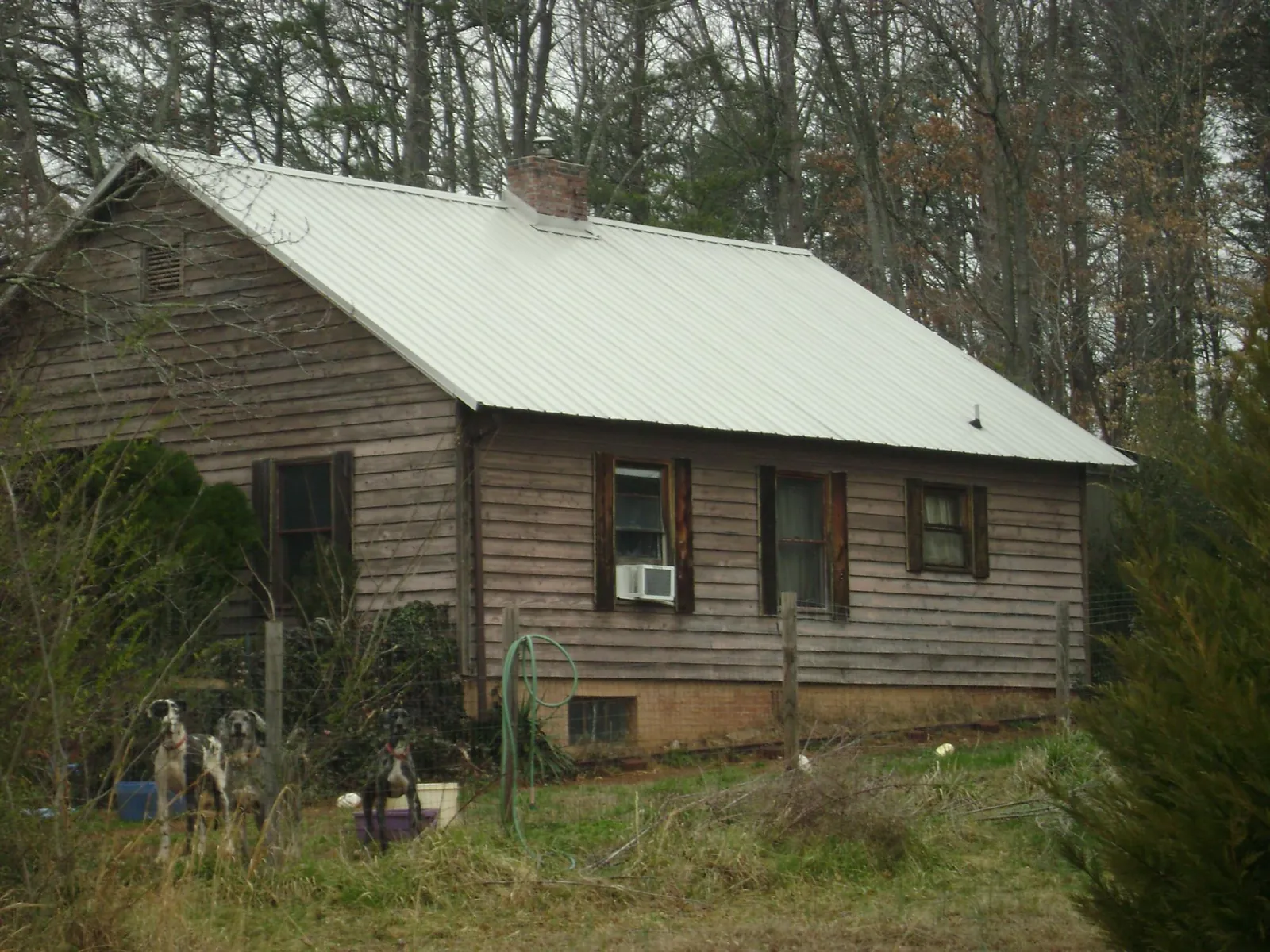 White metal roof on an old wood sided farmhouse, from a Metal Roof Installation job in Newfane